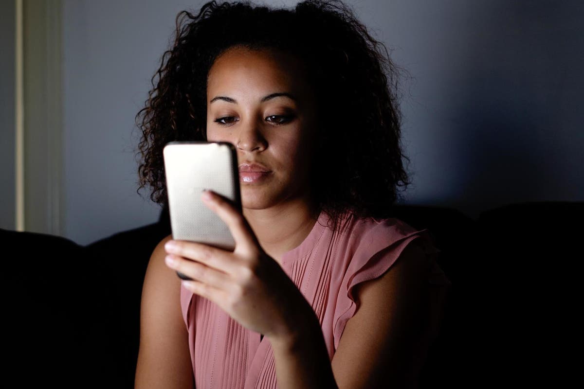 A woman holding a cell phone